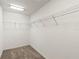 Large walk-in closet with wire shelving and neutral carpeting at 736 Jones Ln, The Villages, FL 32163
