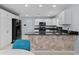 Modern kitchen with island and black appliances at 3401 Fairfield St, The Villages, FL 32162