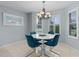 Bright dining room with white table and teal chairs at 3401 Fairfield St, The Villages, FL 32162