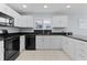 Modern kitchen with white cabinets and black appliances at 3401 Fairfield St, The Villages, FL 32162