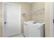 Laundry room with washer, dryer, and built-in shelving at 3401 Fairfield St, The Villages, FL 32162