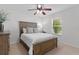 Bright bedroom with wood bed frame and ceiling fan at 3401 Fairfield St, The Villages, FL 32162