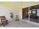 Relaxing screened porch with tiled floor and seating area at 3401 Fairfield St, The Villages, FL 32162