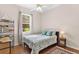 Bright bedroom with a double bed, wood floors, and ample closet space at 5515 Citation Ct, Lady Lake, FL 32159