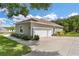 Two-car garage with landscaped surroundings at 5515 Citation Ct, Lady Lake, FL 32159