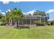 Expansive backyard oasis with lush landscaping and screened pool enclosure at 5515 Citation Ct, Lady Lake, FL 32159