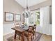 Elegant dining room with hardwood floors, chandelier, and window seating at 5515 Citation Ct, Lady Lake, FL 32159