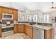 Spacious kitchen featuring stainless steel appliances and granite countertops at 5515 Citation Ct, Lady Lake, FL 32159