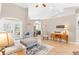 Open living room featuring hardwood floors, and views into the dining room and kitchen at 5515 Citation Ct, Lady Lake, FL 32159