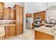 Well-equipped kitchen with ample cabinetry, granite countertops and stainless steel appliances at 5515 Citation Ct, Lady Lake, FL 32159
