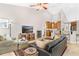 Open living room with a sectional sofa, media console and kitchen views at 5515 Citation Ct, Lady Lake, FL 32159