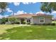 One-story home with a red door and manicured lawn at 5515 Citation Ct, Lady Lake, FL 32159