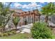Relaxing patio with pergola, lush landscaping, and outdoor grill at 5515 Citation Ct, Lady Lake, FL 32159
