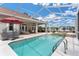 Inviting pool area with screened enclosure, spa, and ample lounge space at 5515 Citation Ct, Lady Lake, FL 32159