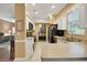 Kitchen with white cabinets, stainless steel appliances, and a breakfast bar at 32915 Crooked Oaks Ln, Leesburg, FL 34748