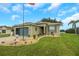 House exterior, gray with blue garage door, landscaping at 32915 Crooked Oaks Ln, Leesburg, FL 34748