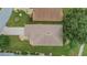 Aerial view showcasing home's roofline, landscaping, and driveway at 32915 Crooked Oaks Ln, Leesburg, FL 34748