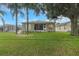 Back exterior view of home showcasing green space at 32915 Crooked Oaks Ln, Leesburg, FL 34748