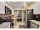 Kitchen with white cabinets, stainless steel appliances and view of dining area at 32915 Crooked Oaks Ln, Leesburg, FL 34748