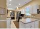 Kitchen with white cabinets, stainless steel appliances, and a breakfast bar at 32915 Crooked Oaks Ln, Leesburg, FL 34748