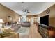 Spacious living room with hardwood floors and large TV at 32915 Crooked Oaks Ln, Leesburg, FL 34748