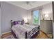 Serene bedroom with wood floors, a ceiling fan, and plenty of natural light at 32915 Crooked Oaks Ln, Leesburg, FL 34748