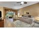 Spacious living room with a recliner sofa and access to a screened porch at 32915 Crooked Oaks Ln, Leesburg, FL 34748