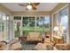 Bright sunroom with wicker furniture and golf course view at 32915 Crooked Oaks Ln, Leesburg, FL 34748