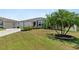 Two-car garage and manicured lawn at 736 Jones Ln, The Villages, FL 32163