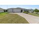 Two-car garage and manicured lawn at 736 Jones Ln, The Villages, FL 32163