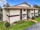 Exterior view of a condo building with a brown roof and white walls at 1547 Ne 2Nd St # F, Ocala, FL 34470