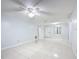 Large living room with light walls, tiled floors, and a ceiling fan at 1547 Ne 2Nd St # F, Ocala, FL 34470