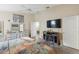 Main bedroom with dresser, TV, and fireplace at 1438 Silver Cove Dr, Clermont, FL 34714