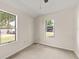 Simple bedroom with neutral walls, carpet, and two windows at 19402 E 5Th St, Umatilla, FL 32784