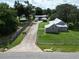 Aerial view of a house with a long driveway and workshop at 19402 E 5Th St, Umatilla, FL 32784