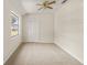 Bedroom with neutral walls, carpet, and a window at 19402 E 5Th St, Umatilla, FL 32784