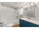 Updated bathroom with navy vanity and white subway tile at 19402 E 5Th St, Umatilla, FL 32784
