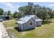Aerial view of a charming grey house with metal roof at 19402 E 5Th St, Umatilla, FL 32784