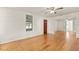Living room featuring hardwood floors, red brick fireplace and large windows at 19402 E 5Th St, Umatilla, FL 32784