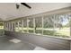 Relaxing screened porch with views of the backyard and trees at 19402 E 5Th St, Umatilla, FL 32784