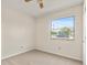 Simple bedroom with neutral walls, carpet, and a large window at 19402 E 5Th St, Umatilla, FL 32784