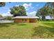 Orange house with metal roof and green lawn at 10367 Se Sunset Harbor Rd, Summerfield, FL 34491