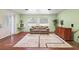 Living room with hardwood floors and large windows at 10367 Se Sunset Harbor Rd, Summerfield, FL 34491