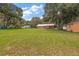 Spacious backyard with a large grassy area and detached shed at 10367 Se Sunset Harbor Rd, Summerfield, FL 34491