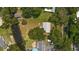 Aerial view showing home, detached garage, and canal at 10367 Se Sunset Harbor Rd, Summerfield, FL 34491
