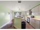 Kitchen with island, updated cabinets, and backyard access at 10367 Se Sunset Harbor Rd, Summerfield, FL 34491