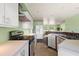 Kitchen with appliances, updated cabinets, and a breakfast bar at 10367 Se Sunset Harbor Rd, Summerfield, FL 34491