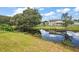 Lovely view of the canal and reflection of the house at 10367 Se Sunset Harbor Rd, Summerfield, FL 34491