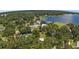 Aerial view showcasing waterfront community and lake access at 10367 Se Sunset Harbor Rd, Summerfield, FL 34491