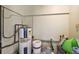 Unfinished basement area with water heater and paint cans at 10367 Se Sunset Harbor Rd, Summerfield, FL 34491